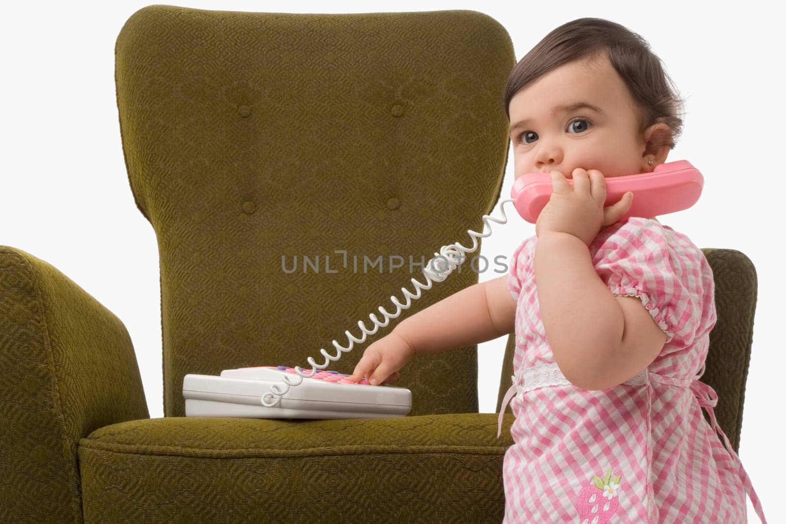 Close_up of a girl playing with a toy phone