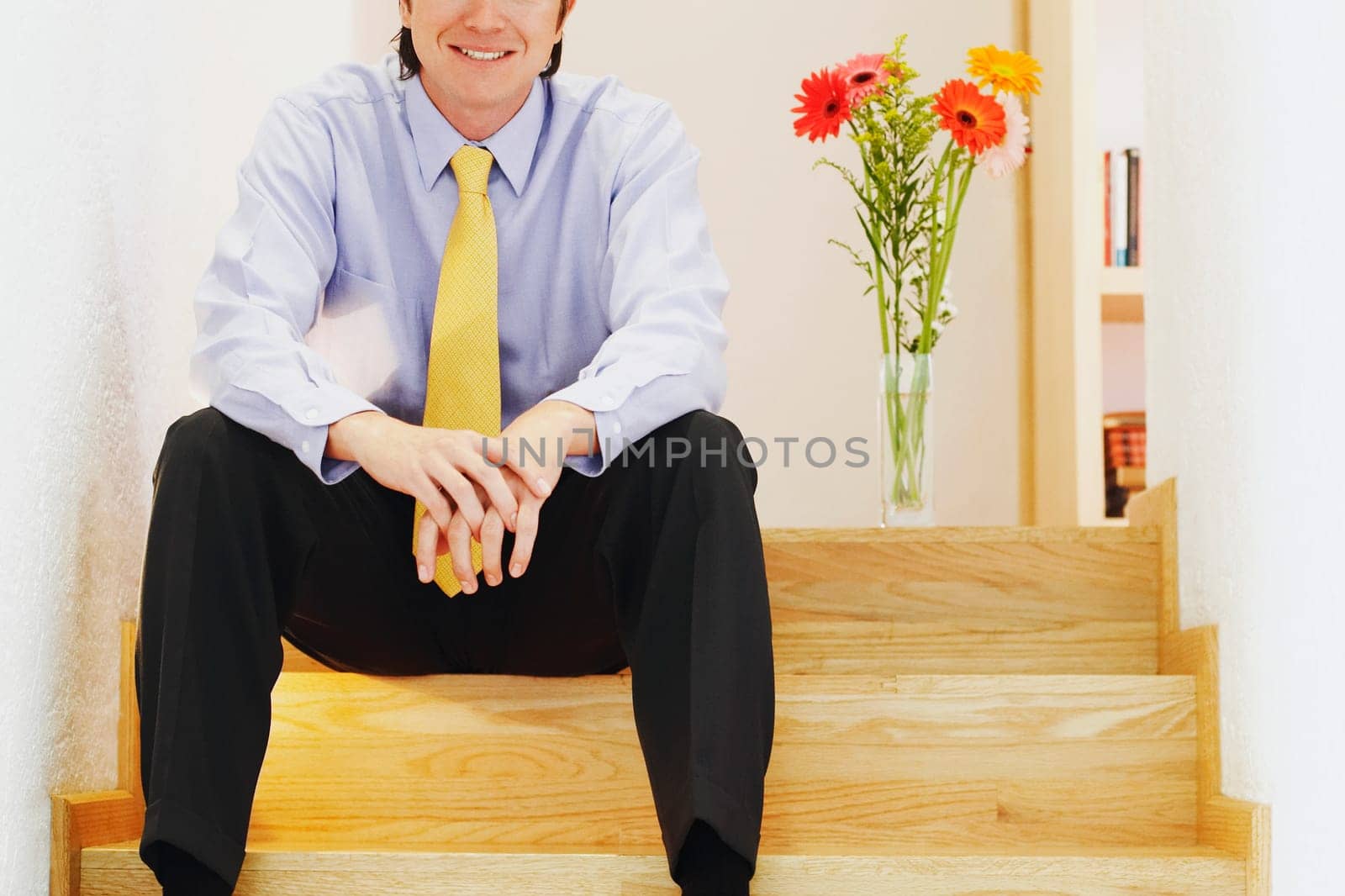 Close-up of a businessman sitting on a staircase and smiling