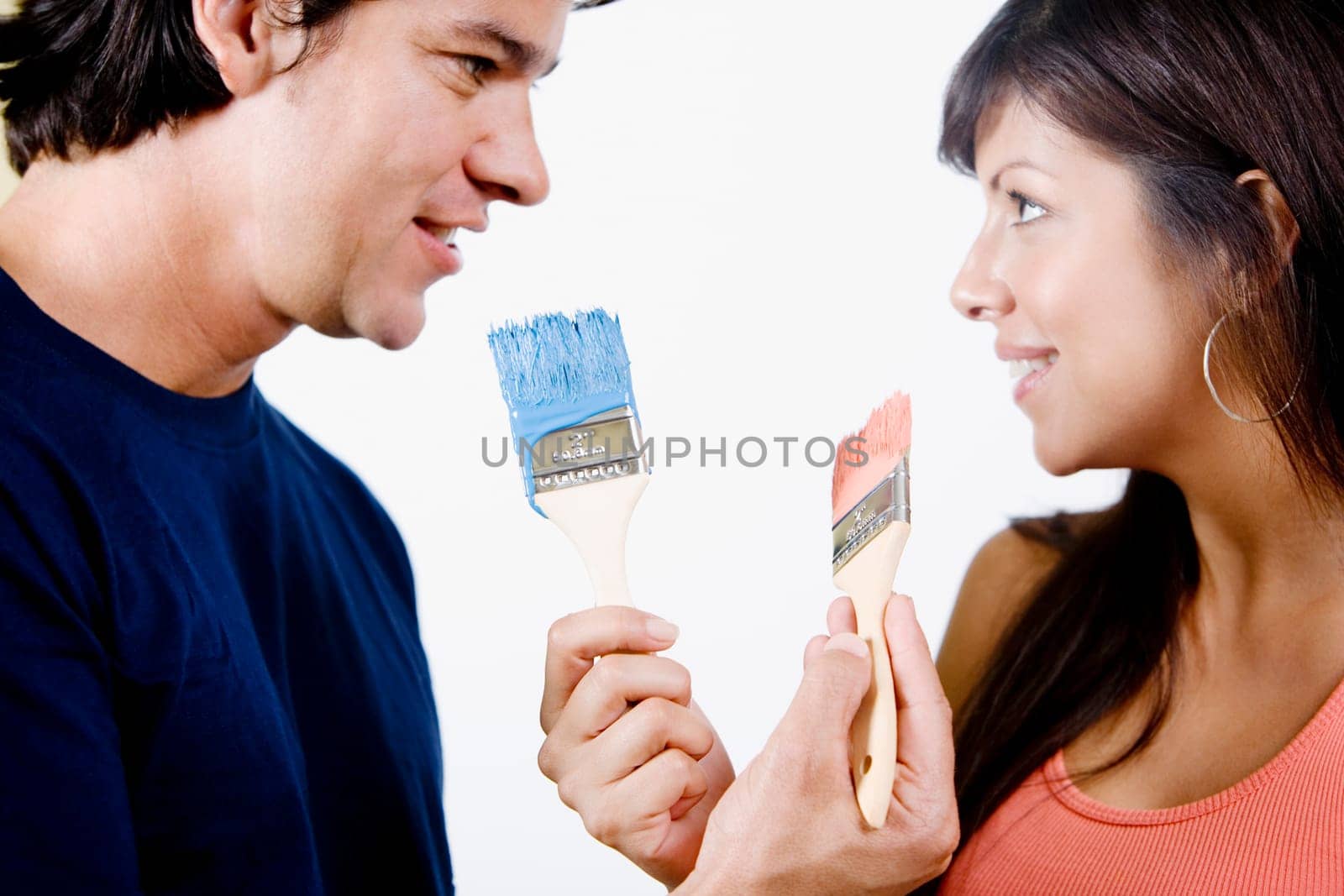 Close-up of a couple holding paintbrushes