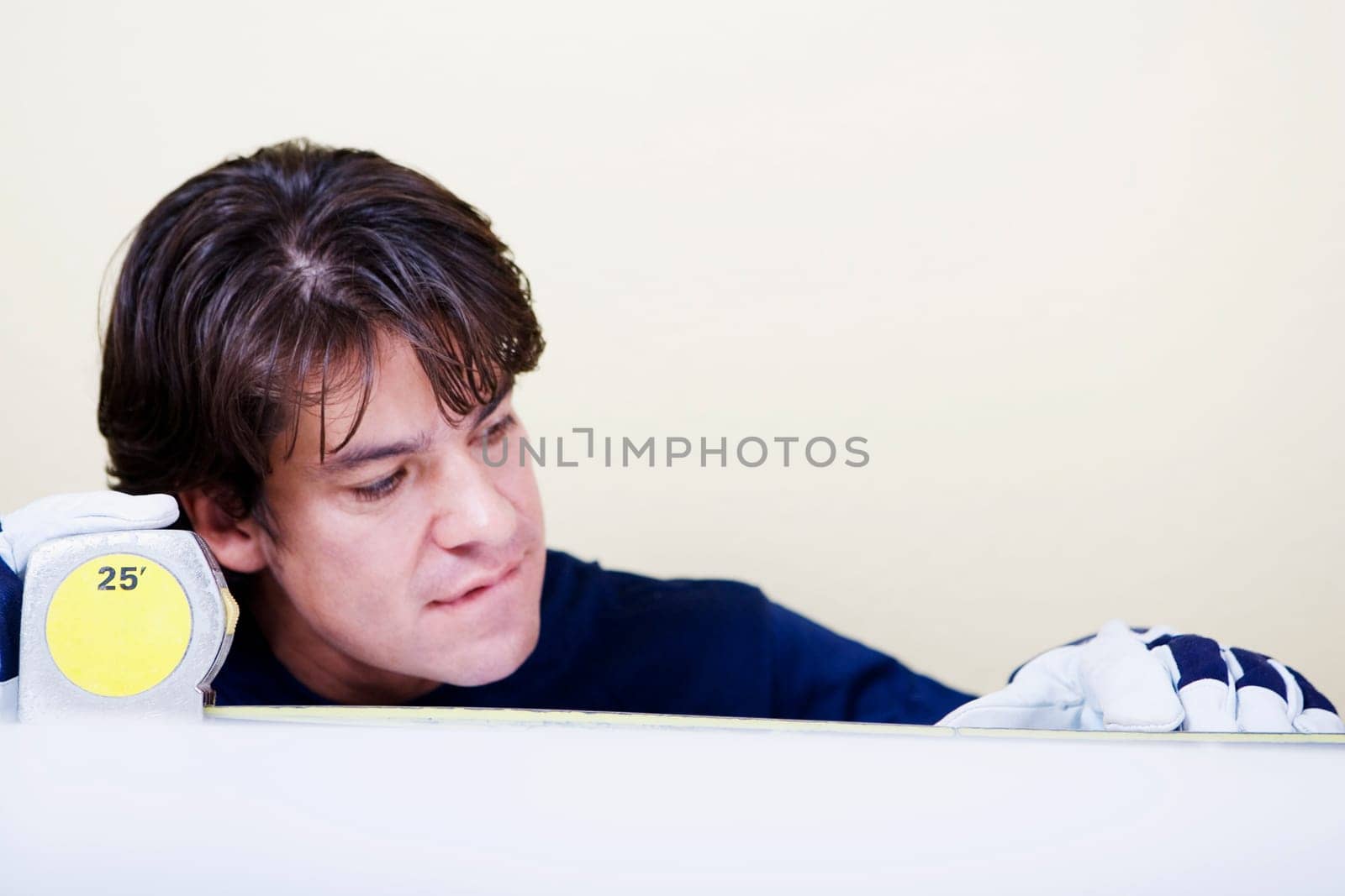 Mid adult man measuring with a measuring tape