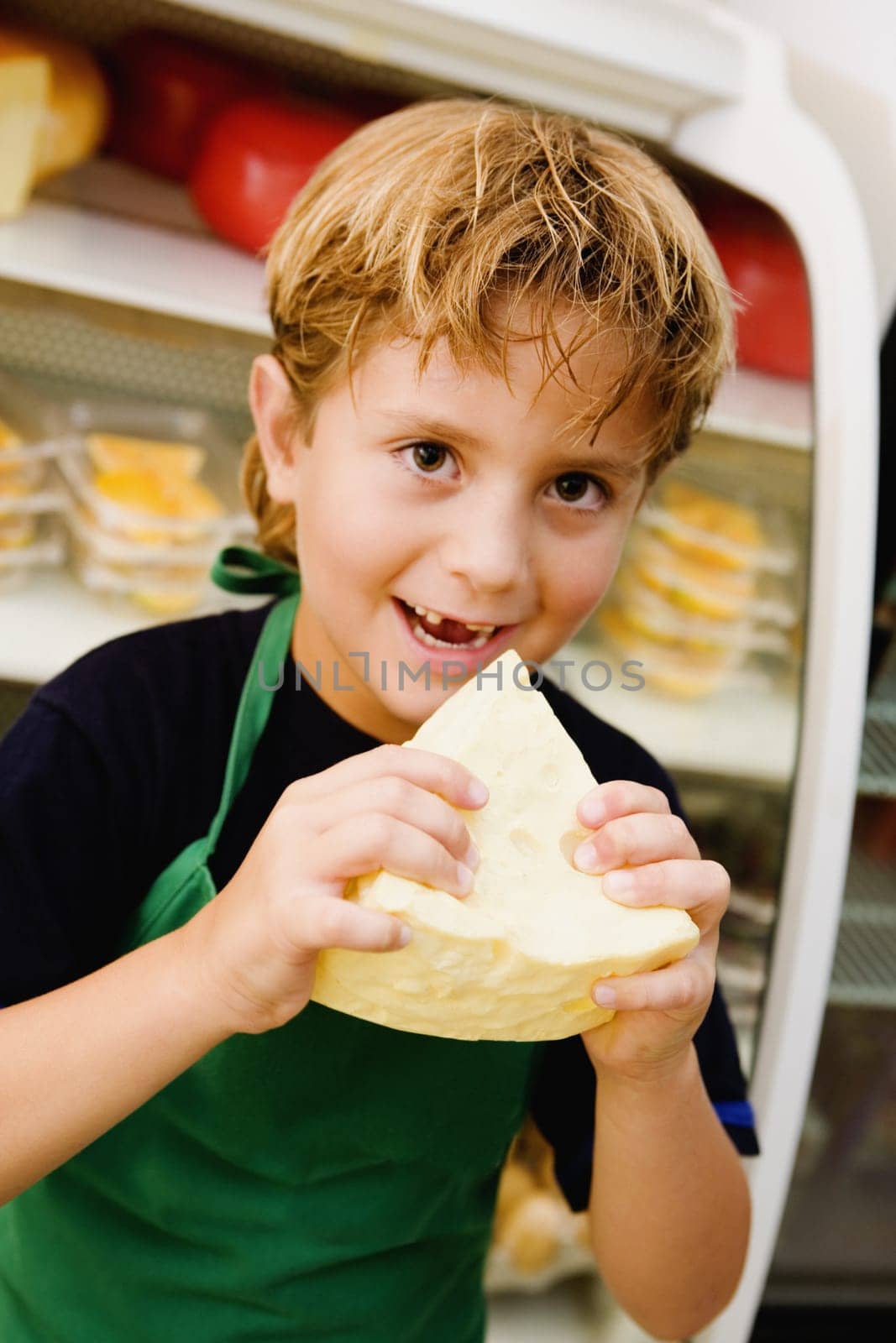 Portrait of a boy eating cheese
