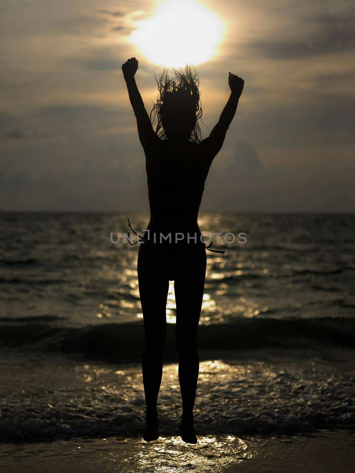 Silhouette of a young woman jumping