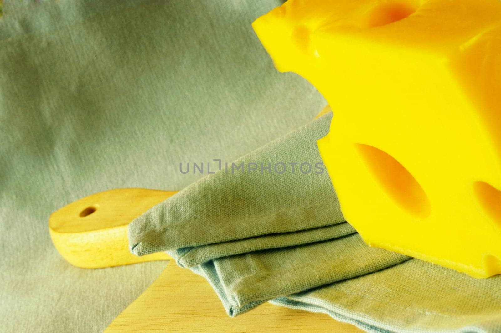 Close-up of cheese and a napkin on a cutting board