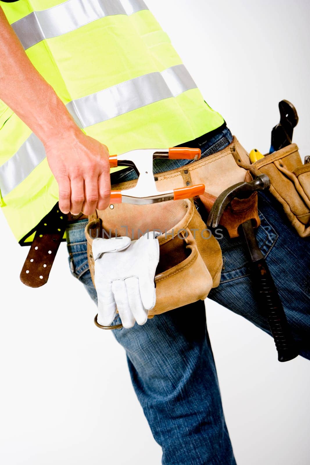Mid section view of a man wearing a tool belt around his waist