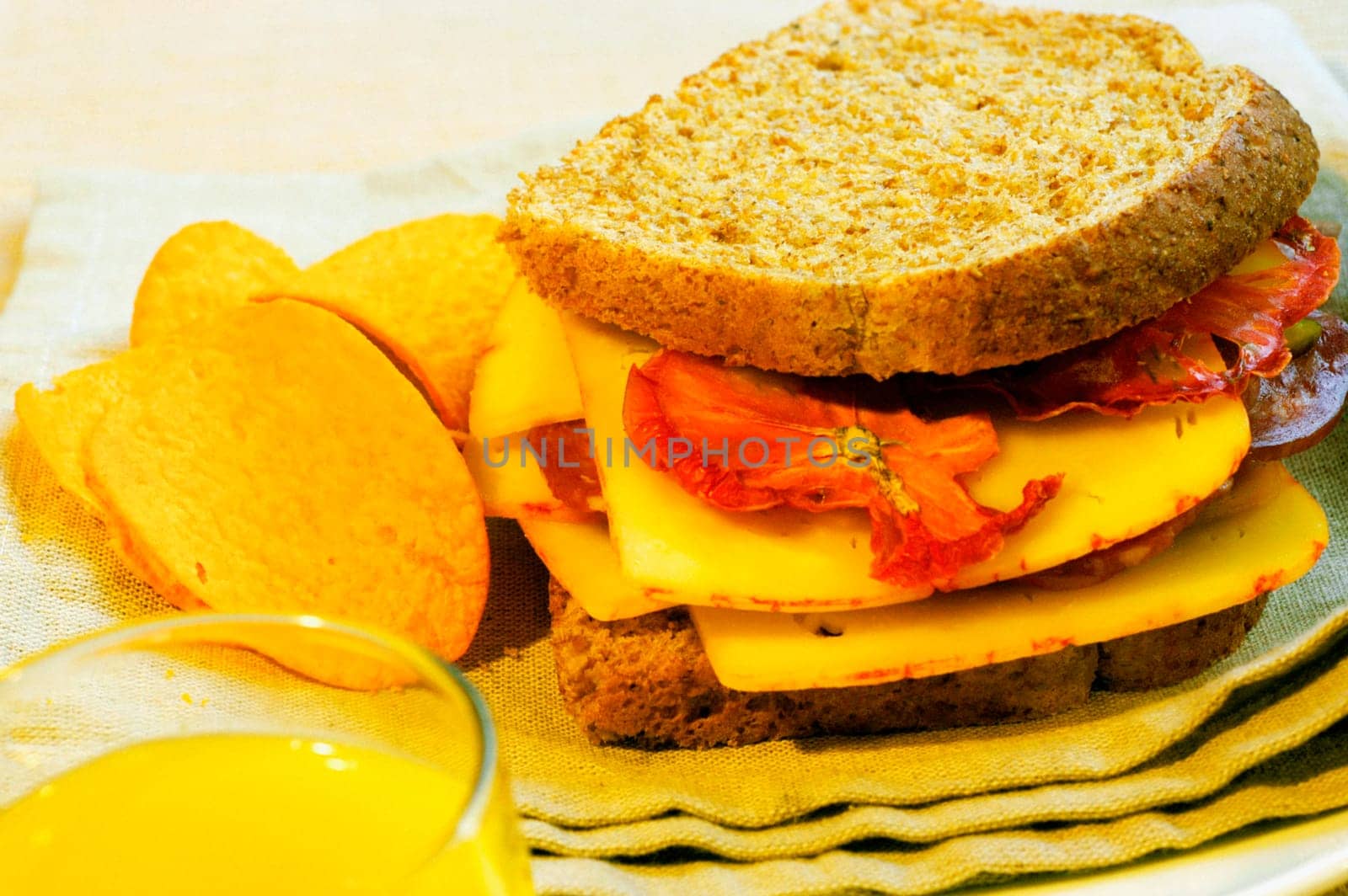 Close-up of a sandwich with potato chips on a napkin
