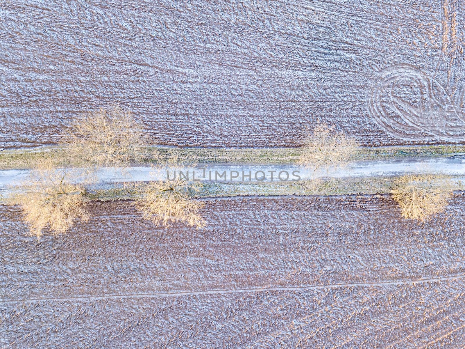 winter road, landscape covered by morning frost, top down aerial view, landscape. Simplicity concept landscape composition.