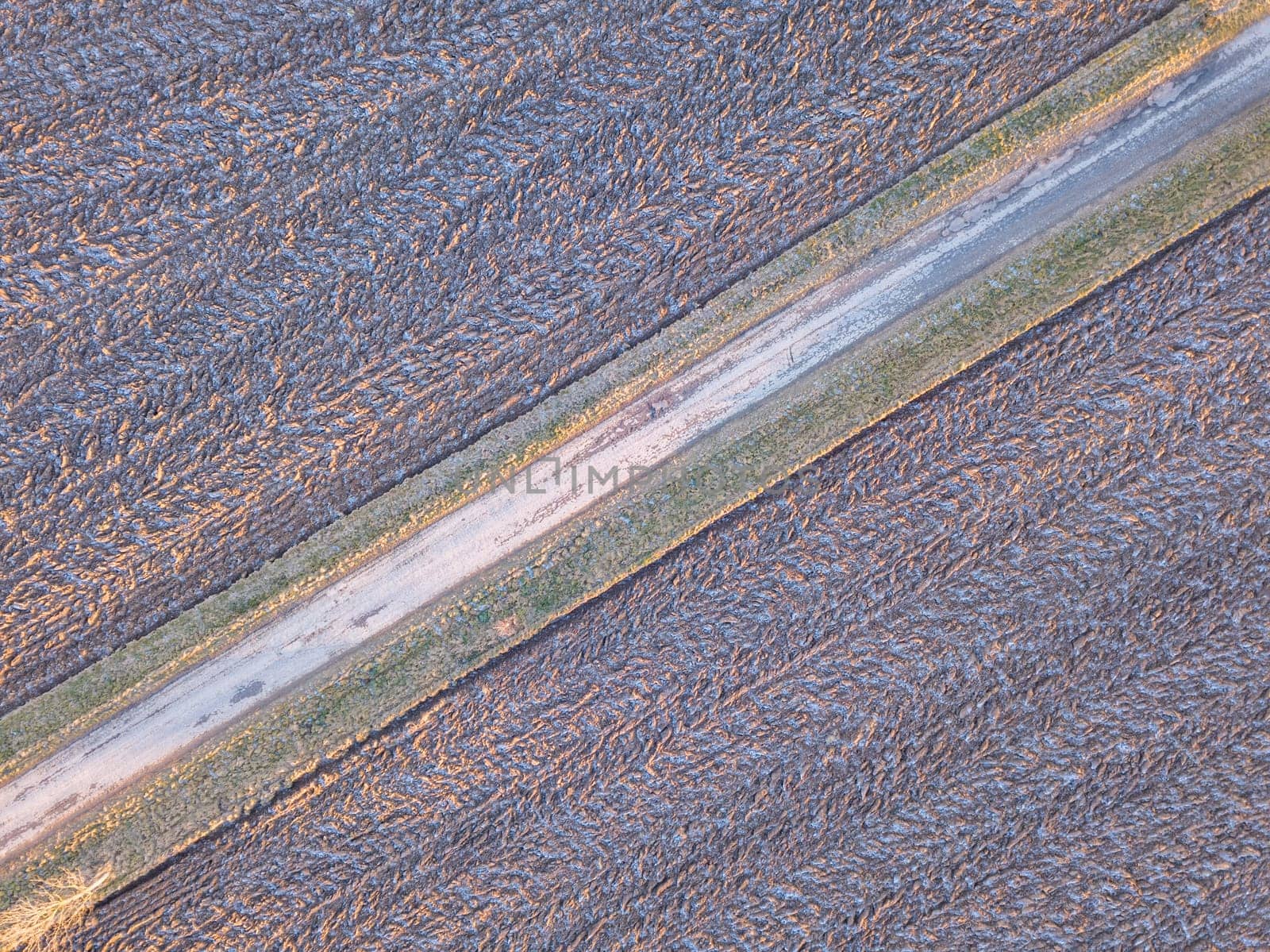 winter road, landscape covered by morning frost, top down aerial view, landscape. Simplicity concept landscape composition.