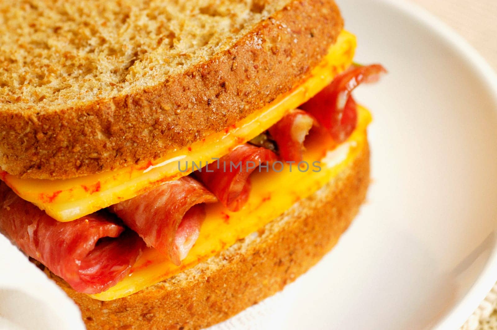 Close-up of roast beef and cheese sandwich on a plate