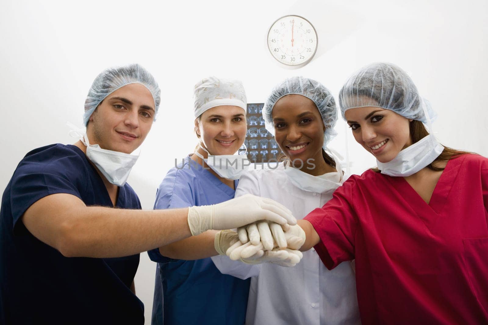 Close-up of surgeons stacking hands on top of each other