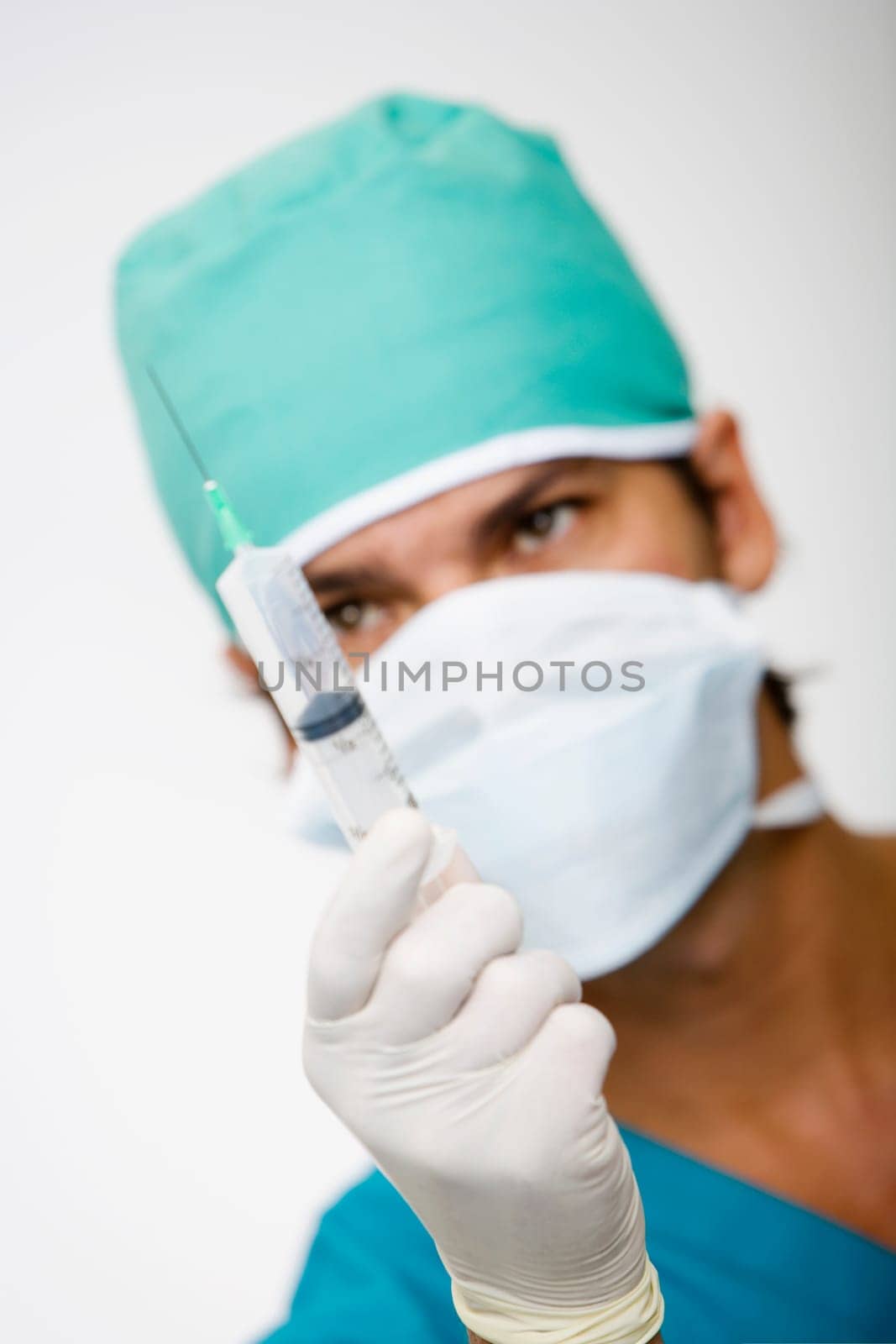 Close-up of a male surgeon holding a syringe
