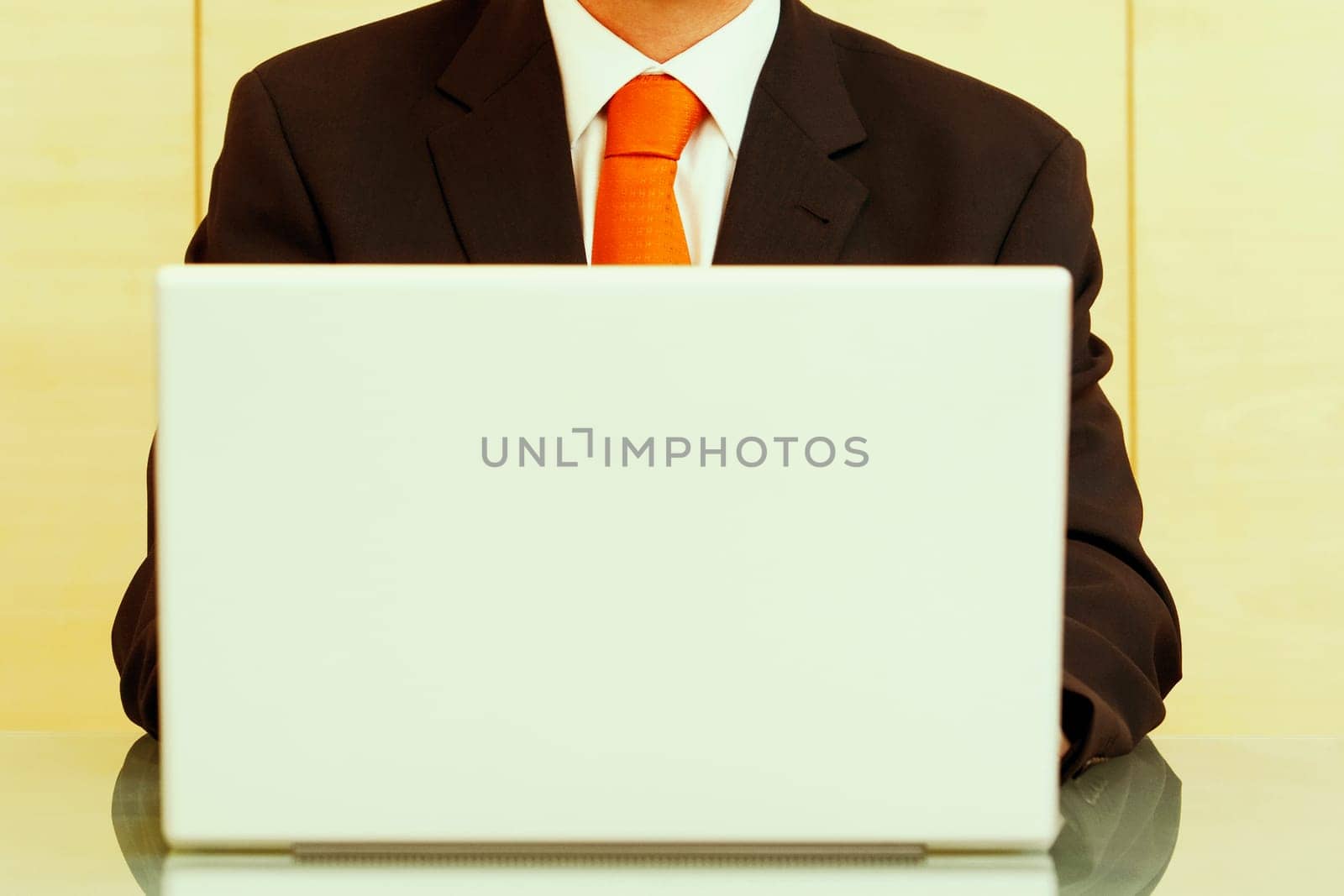 Mid section view of a businessman using a laptop