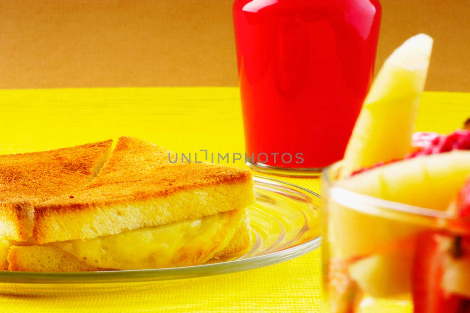 Close-up of bread and fruit salad with a glass of juice
