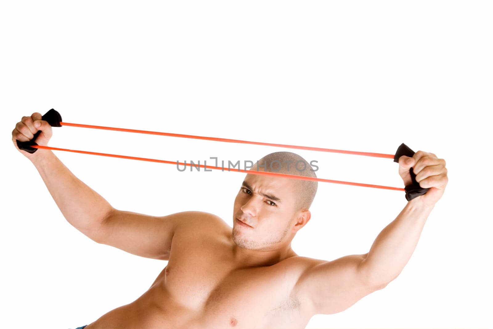 Portrait of a young man stretching a resistance band