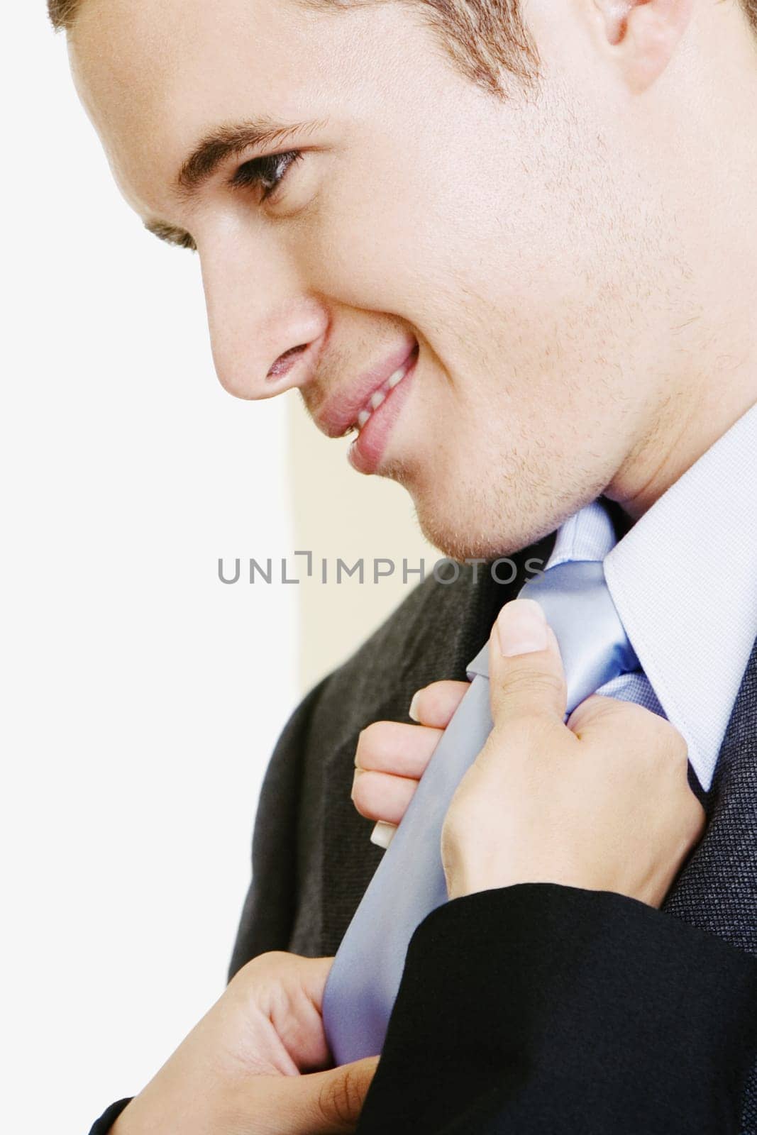 Close-up of a womanŽs hands adjusting a businessmanŽs tie