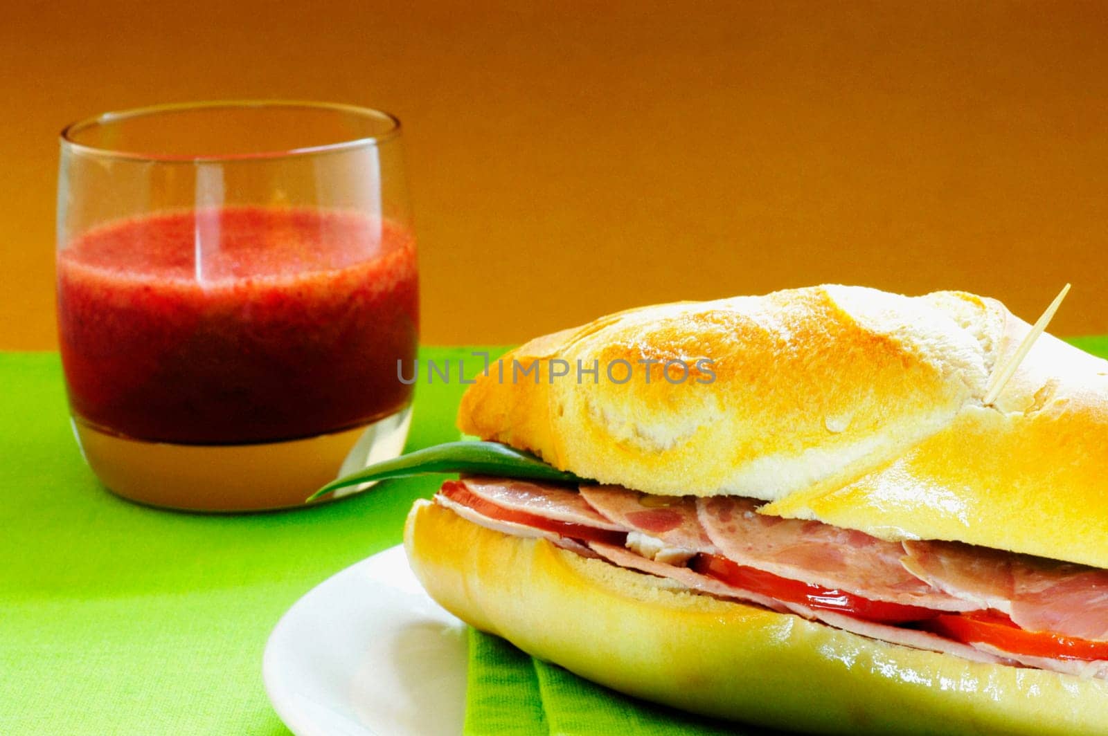 Close-up of a sandwich with a glass of juice