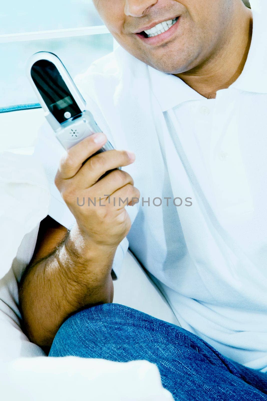 Close-up of a young man operating a mobile phone