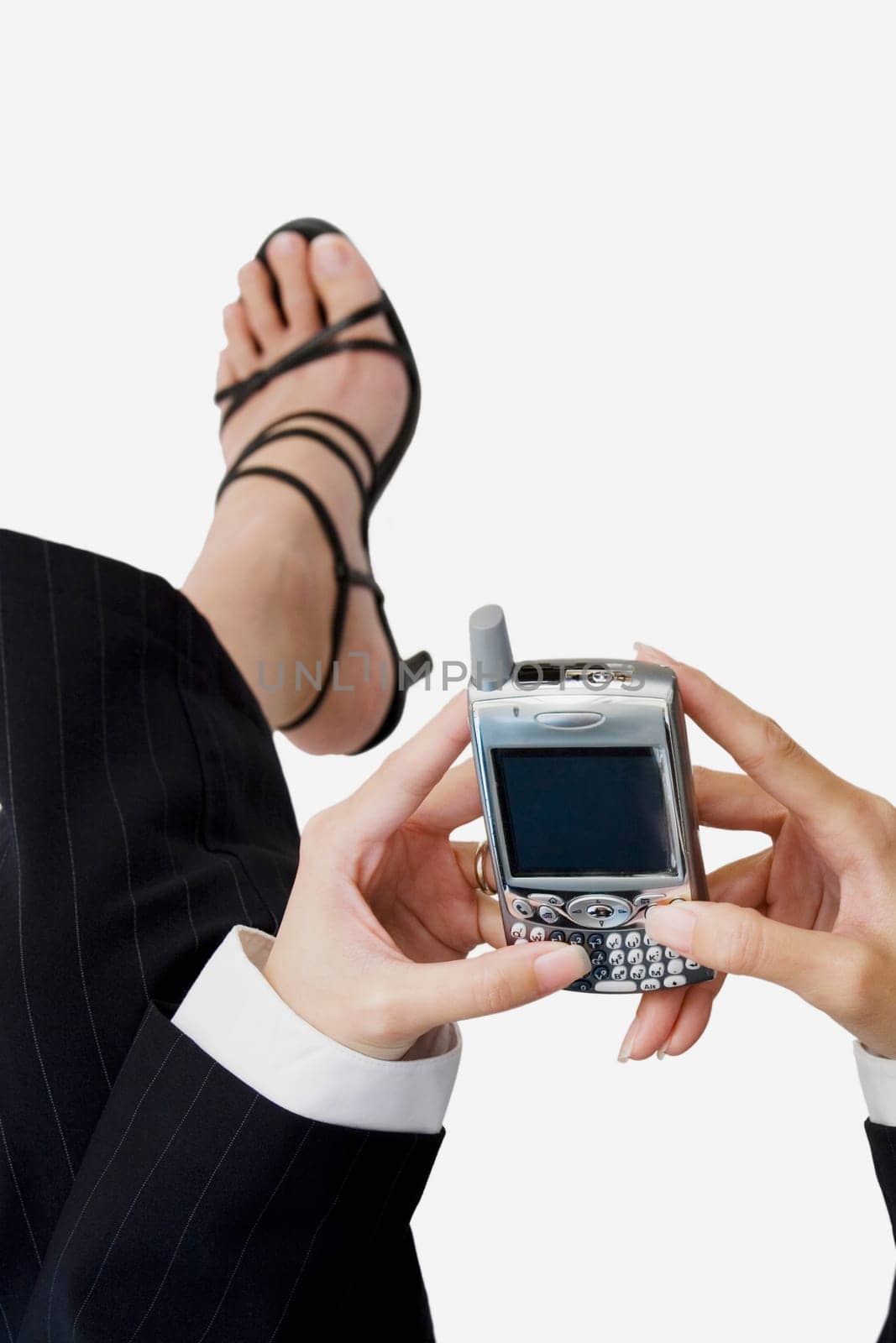 Low section view of a businesswoman operating a mobile phone