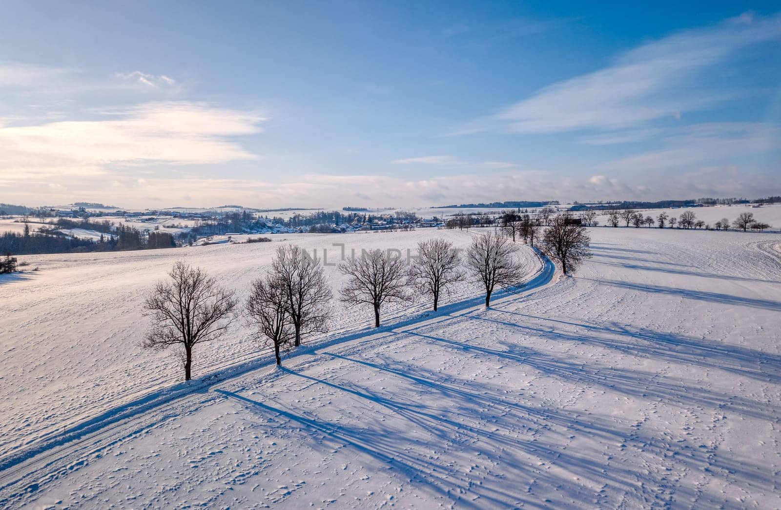 Winter landscape with rural road on a sunny frosty day. Czech Republic, Vysocina Highland region, Europe
