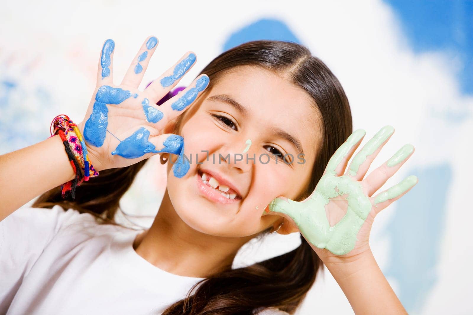 Portrait of a girl showing paint on her palms