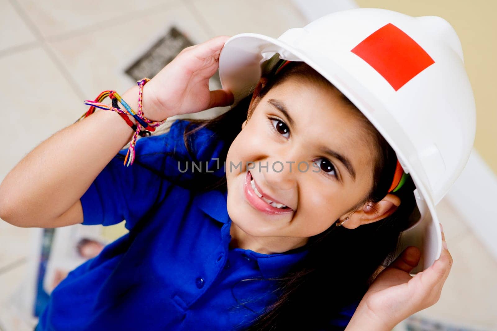 Close-up of a girl wearing a hardhat and smiling