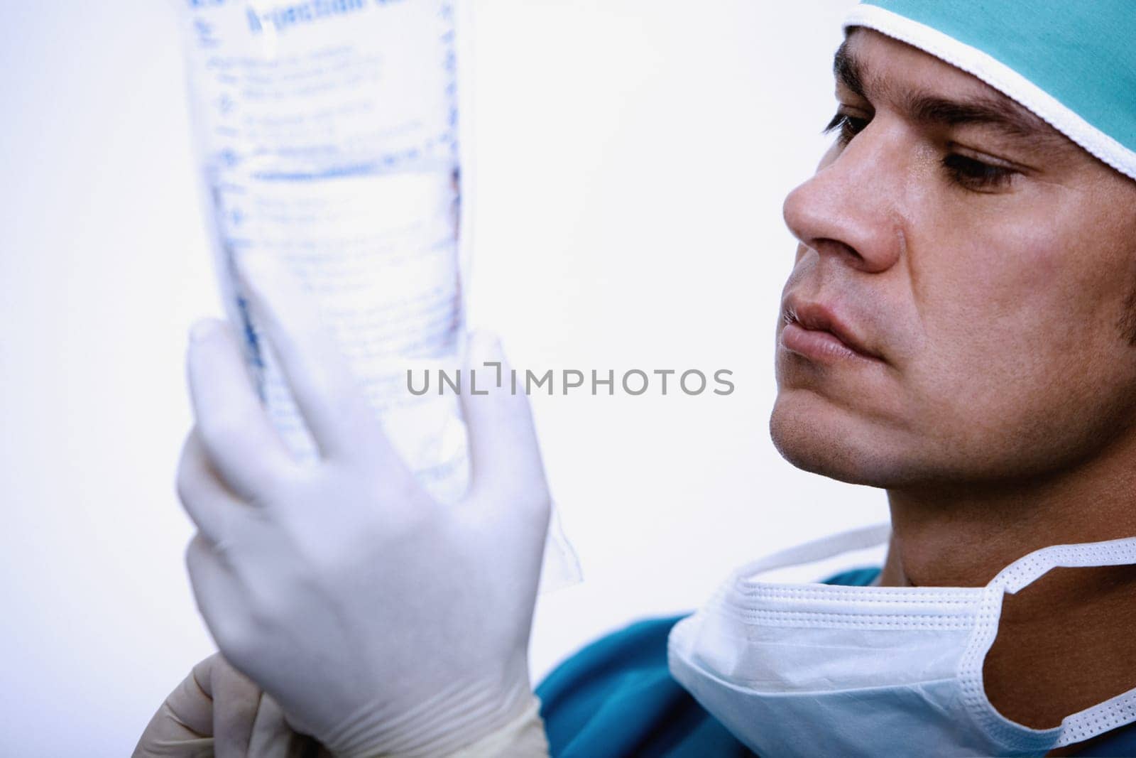 Close-up of a surgeon holding a saline drip