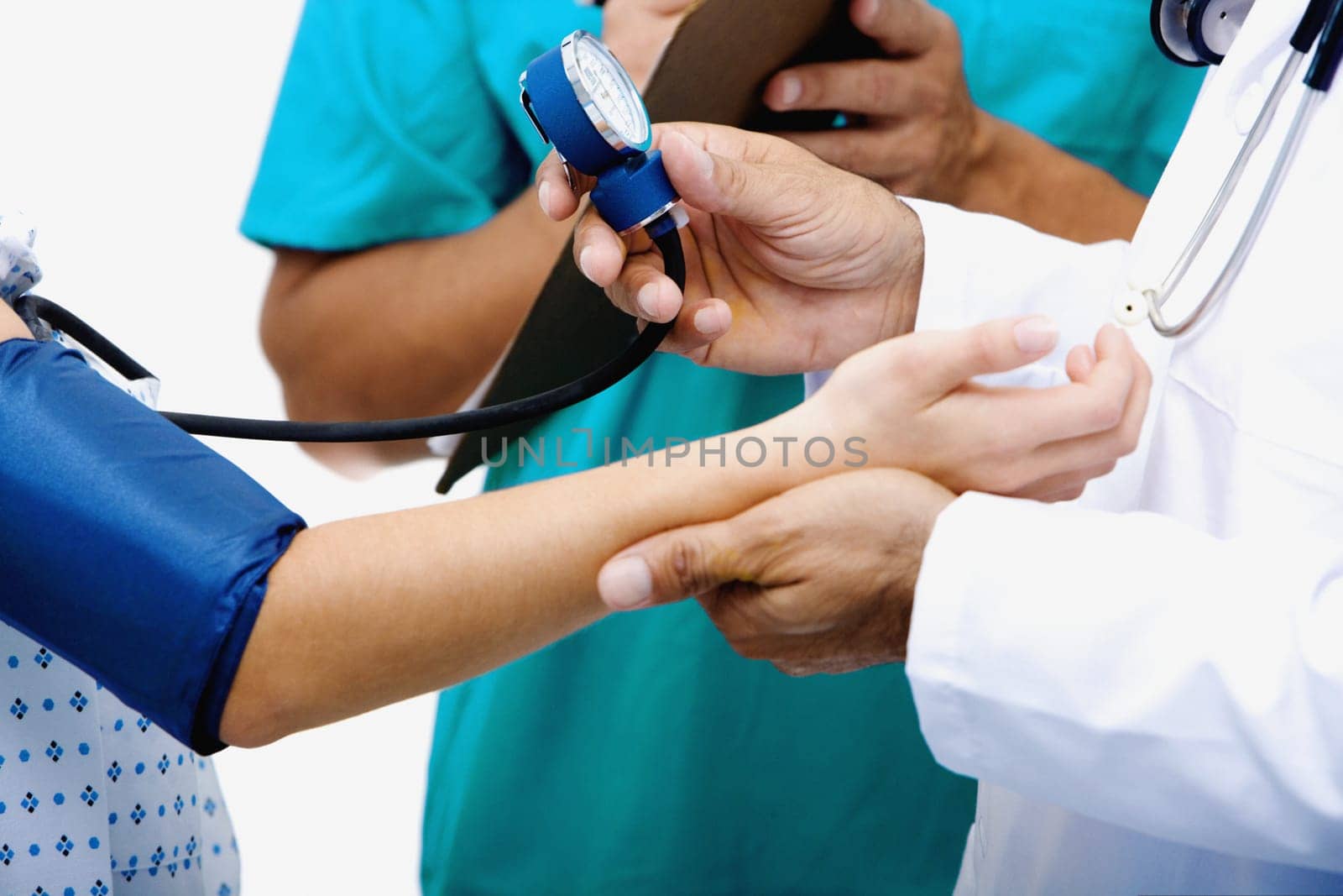 Mid section view of a male doctor measuring blood pressure of a female patient