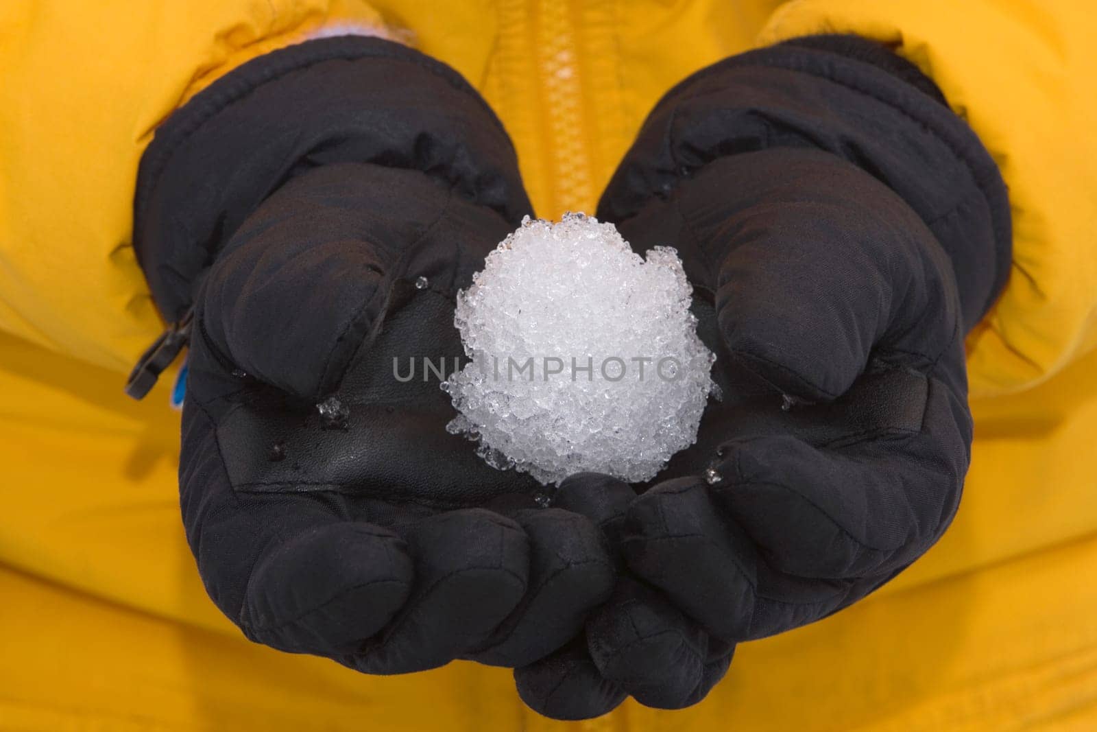 Mid section view of a person holding a snowball
