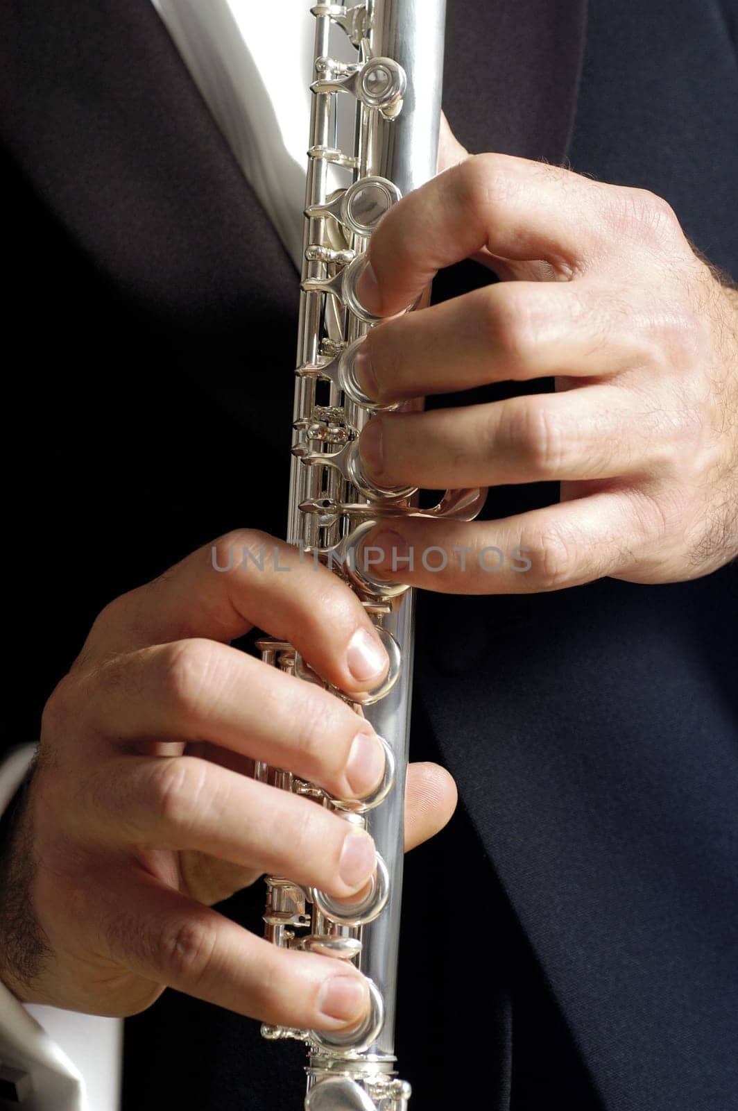 Mid section view of a musician playing the flute