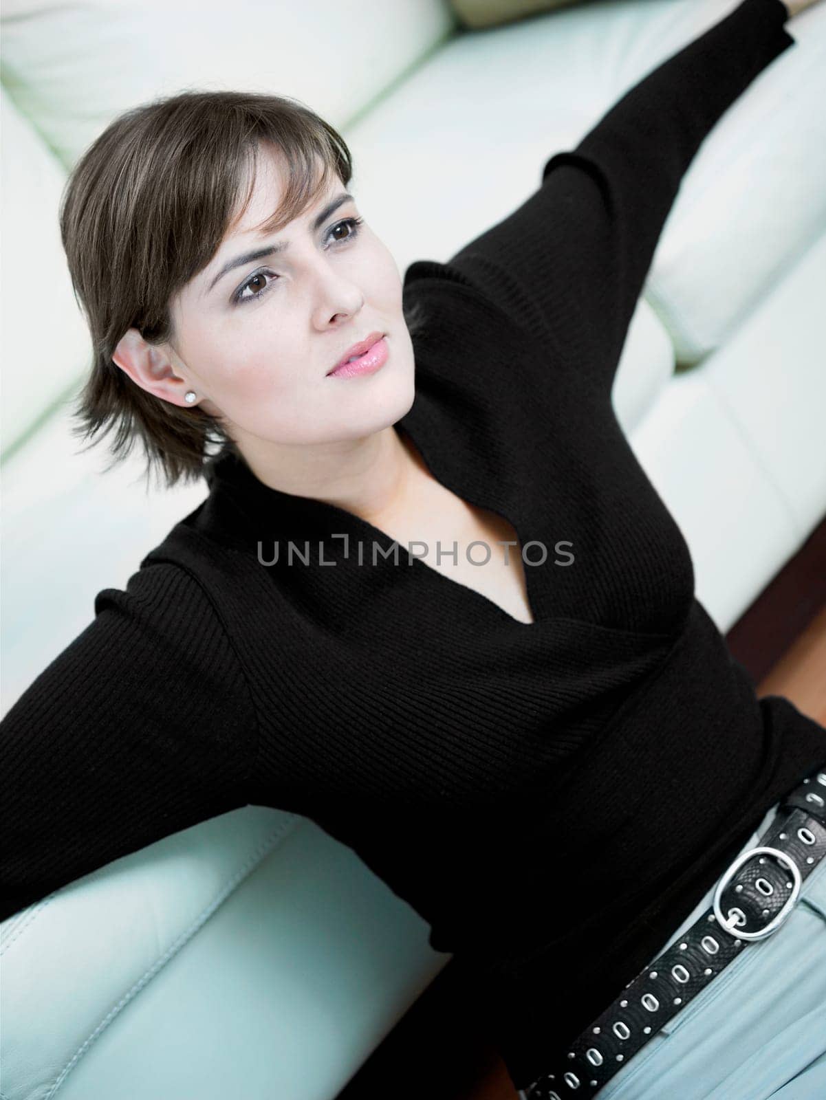 Close-up of a businesswoman leaning against a couch