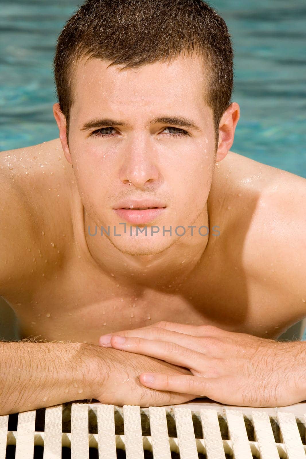 Portrait of a young man in a swimming pool