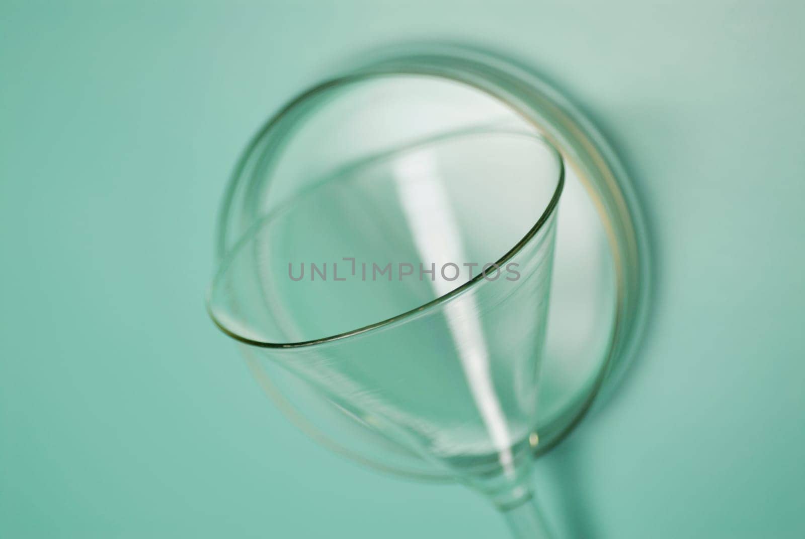 Close_up of a glass funnel with a petri dish