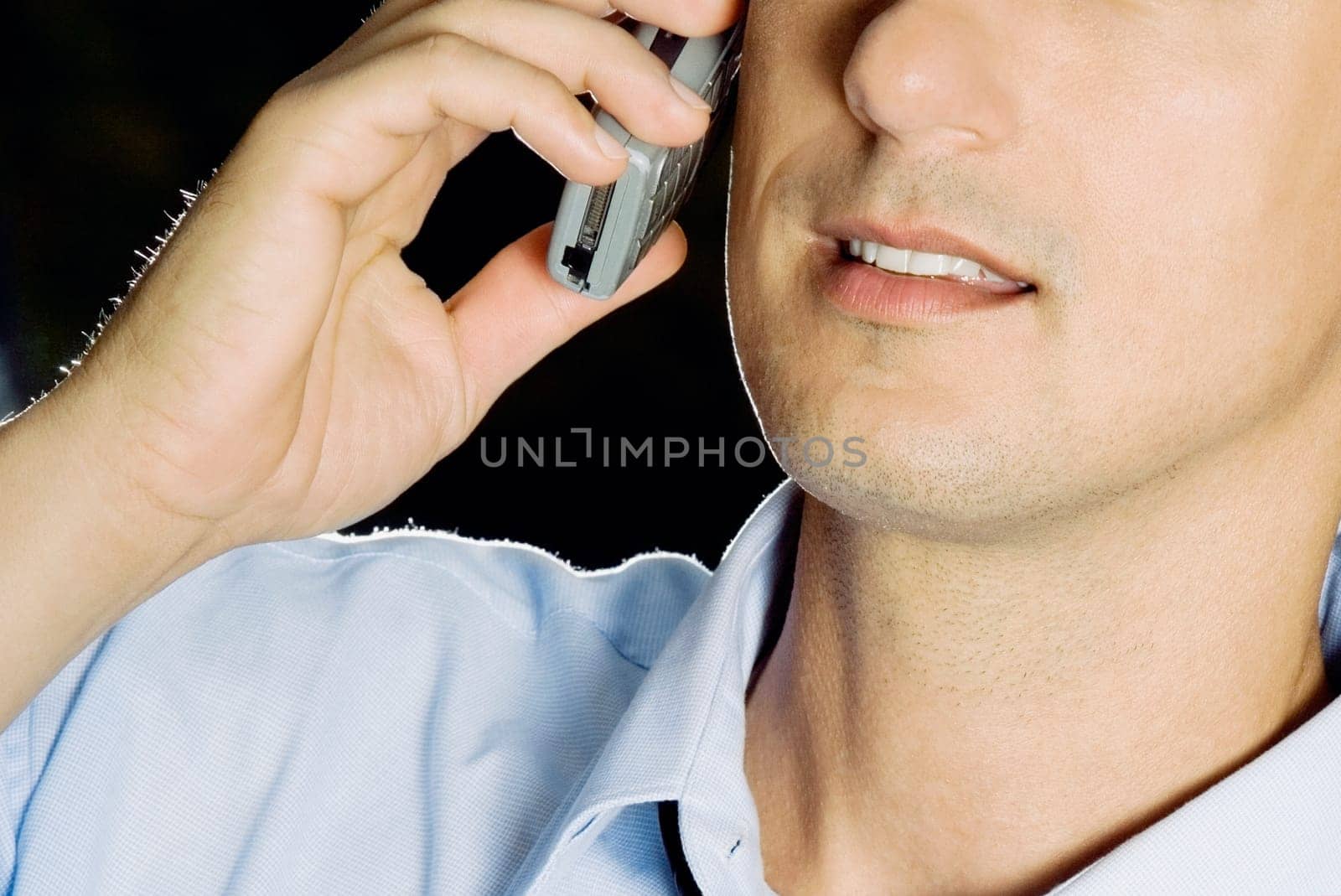 Close-up of a young man using a mobile phone