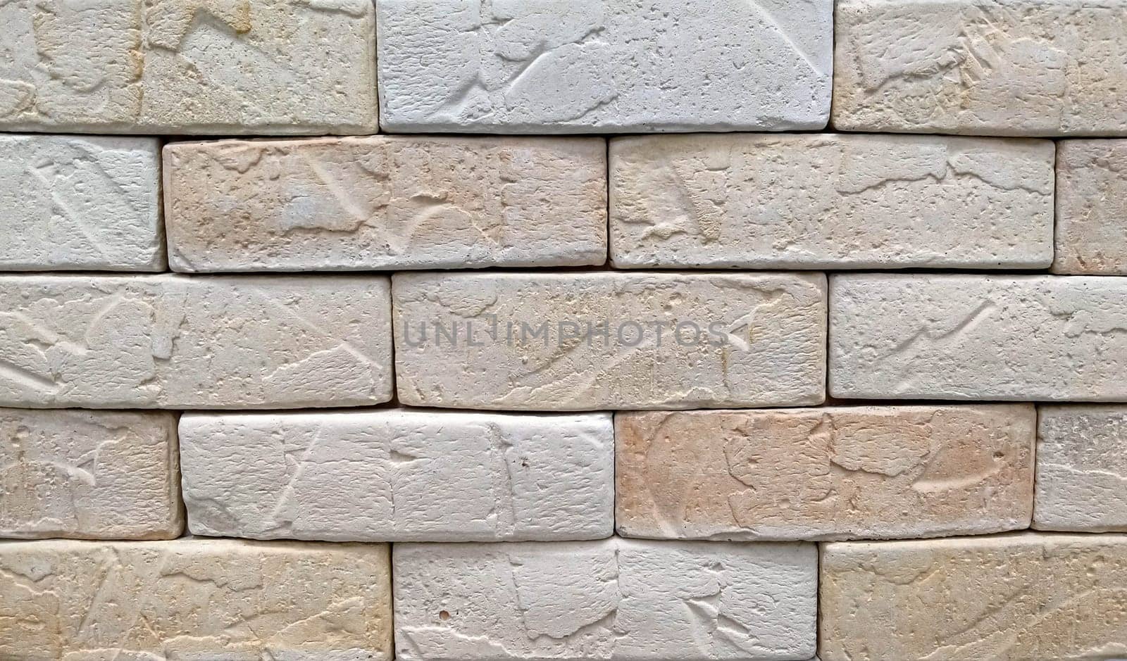 Beige tone stone brick background. Beige brick wall background texture close up