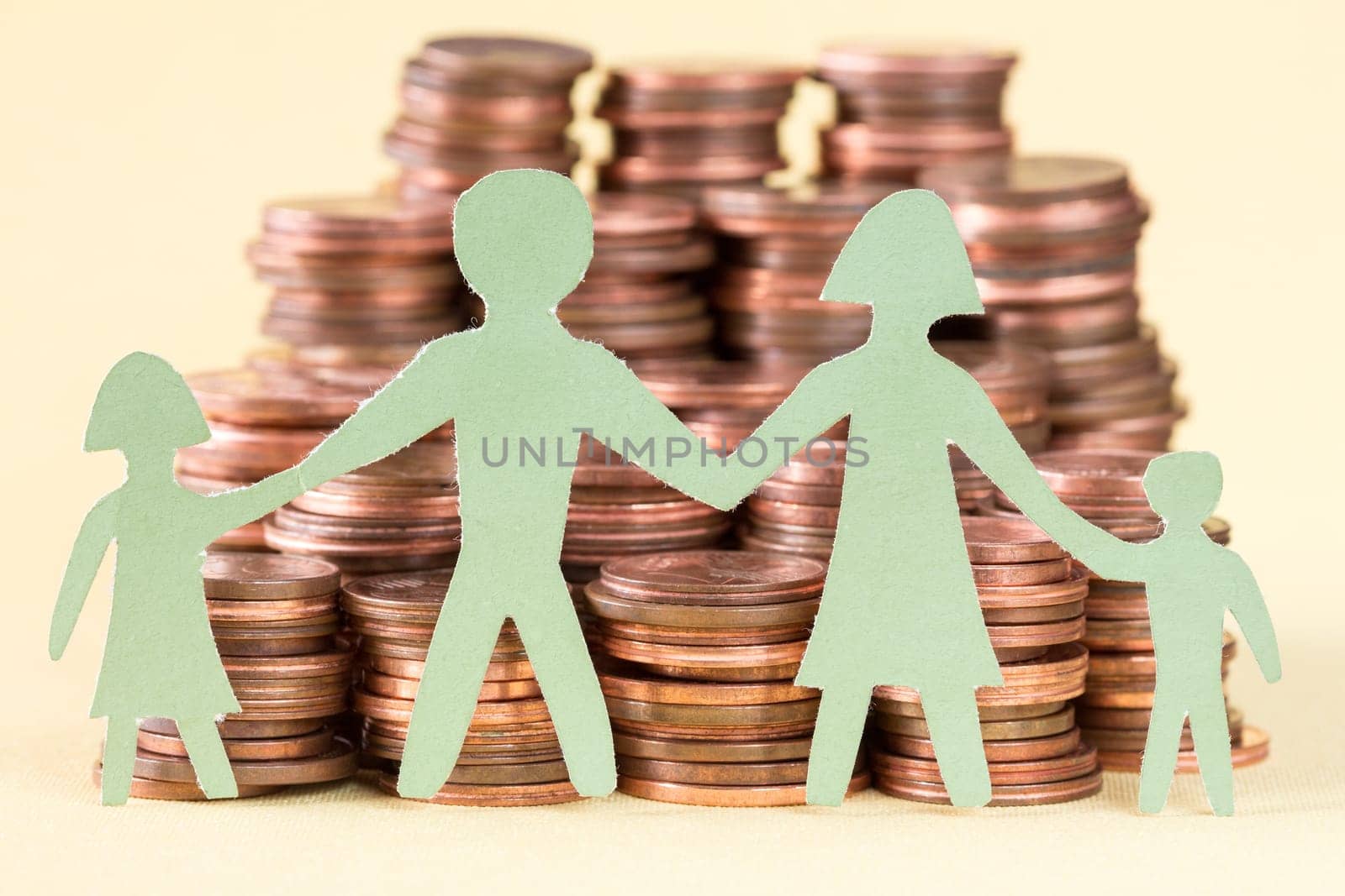 Paper family and huge pile of coins.Investments and people concept.