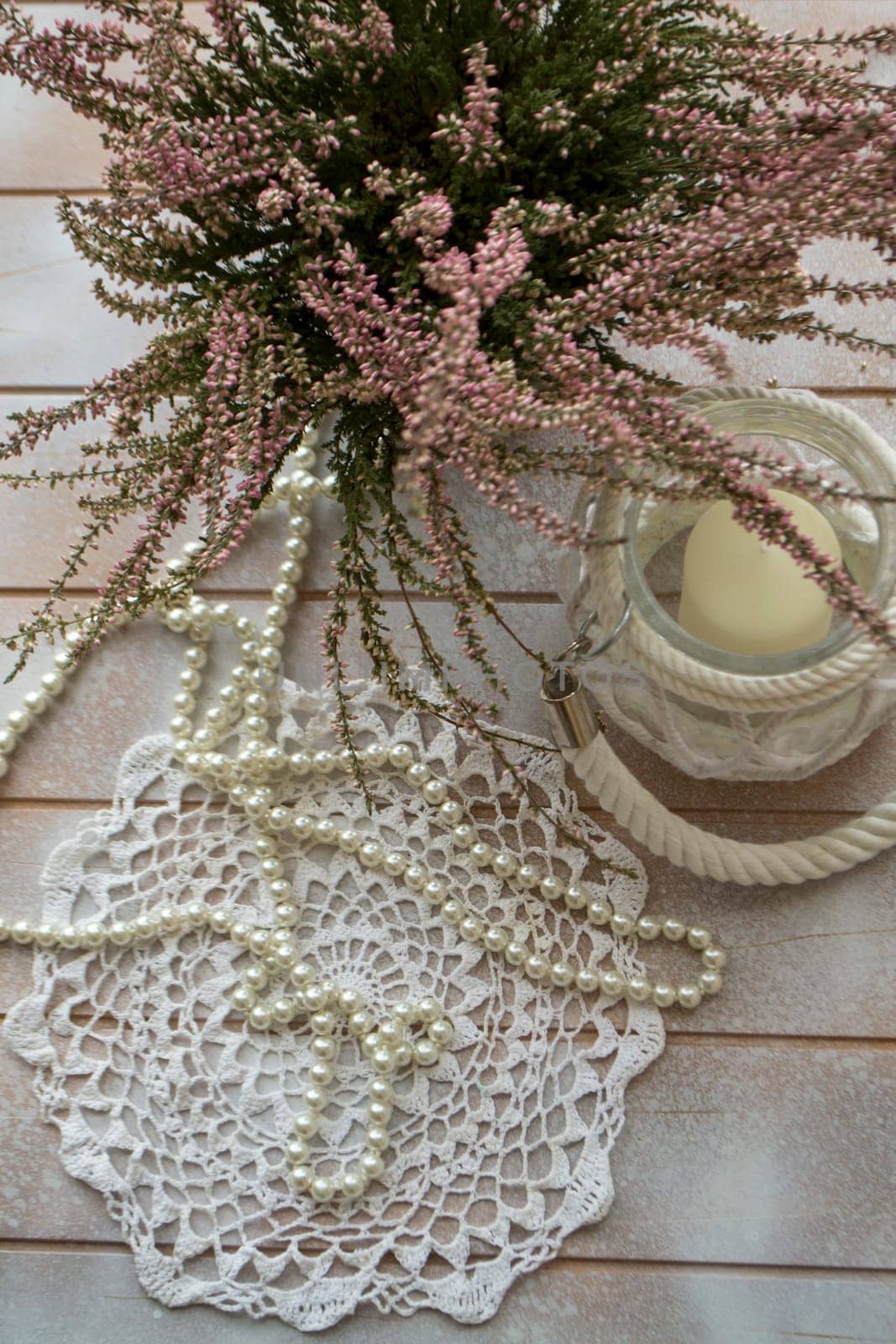 A bouquet of heather on a white shabby table, vertical image