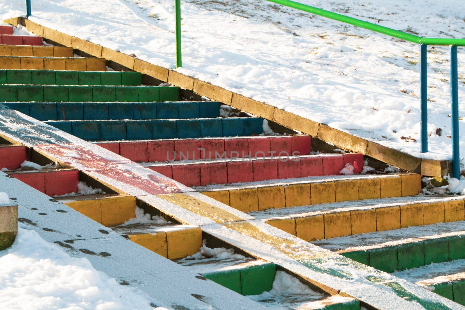 stairs colored in rainbow colors. Diversity multicolored flag concept, snowy day in winter