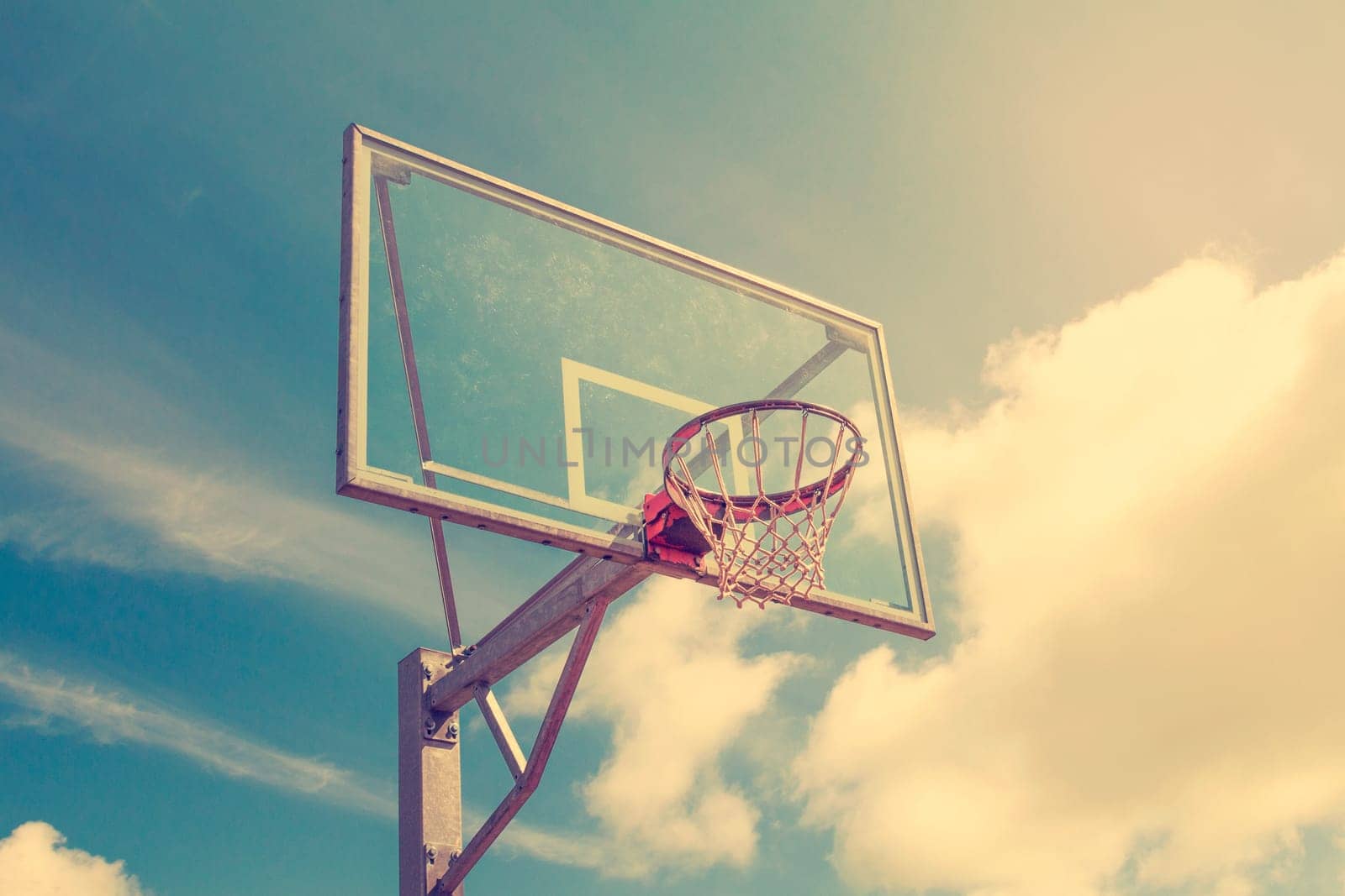 Basketball hoop against a evening sky background