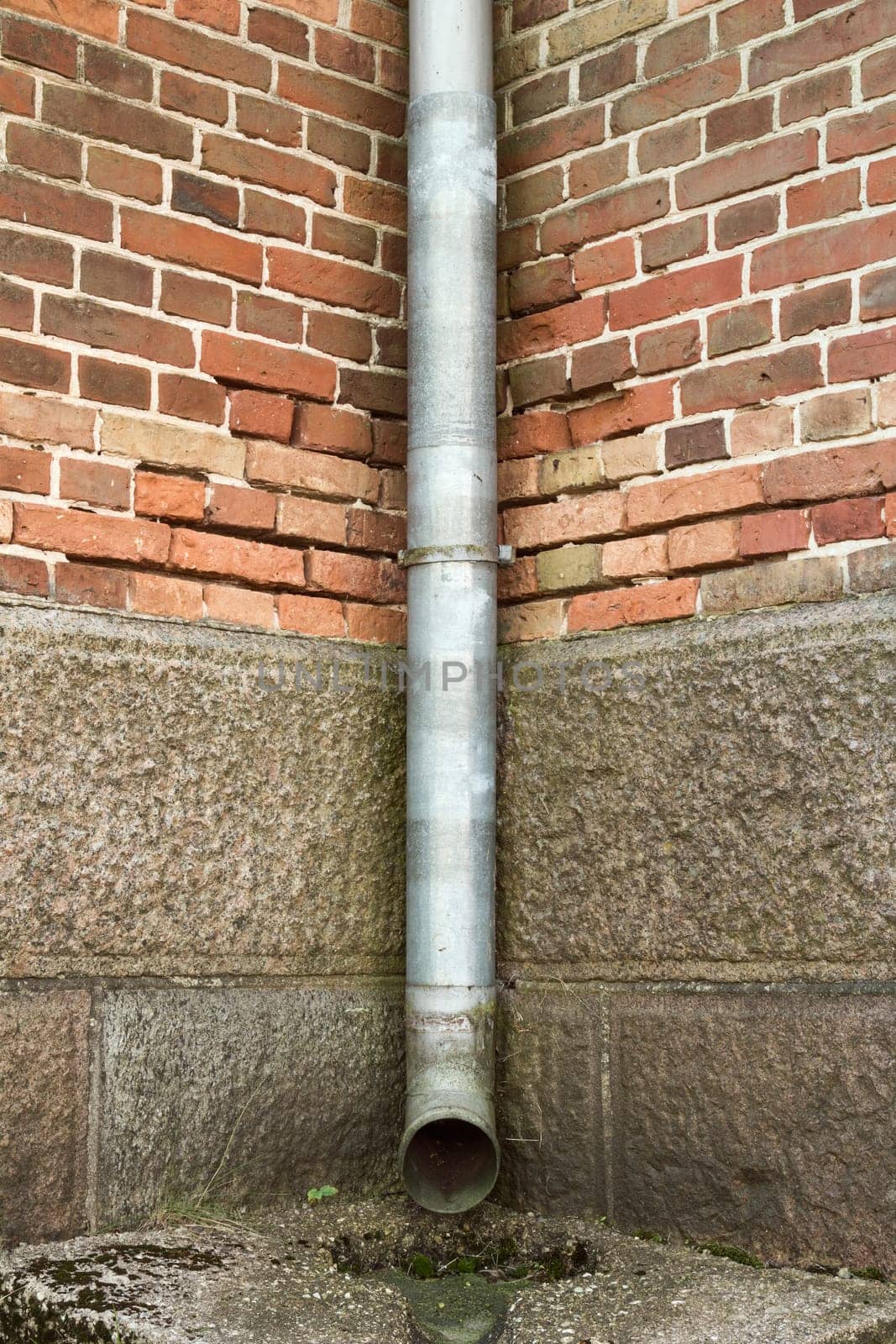Vintage brick wall texture with drainpipe
