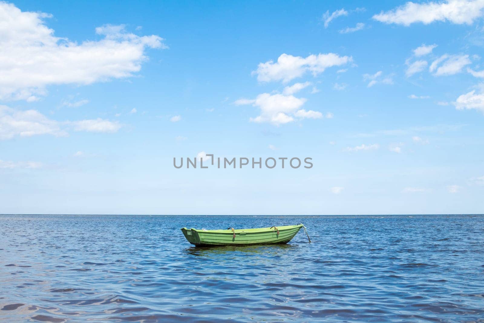 Empty fishing boat floating out to sea