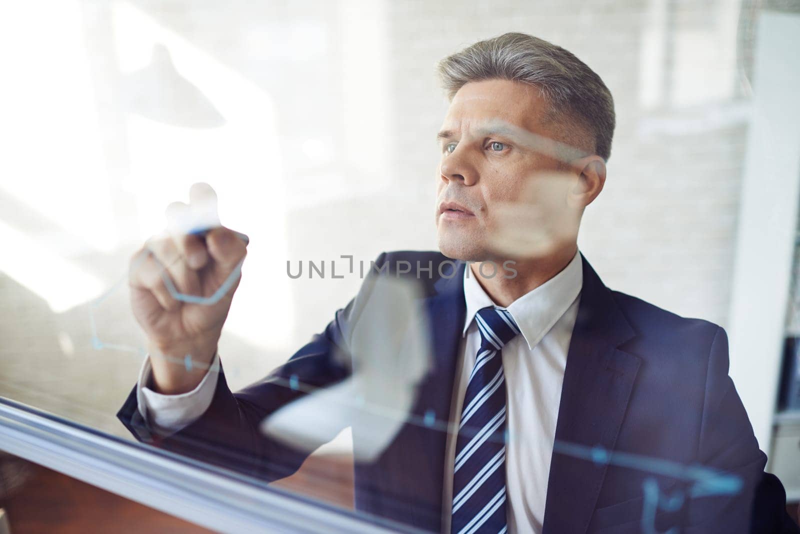 Concentrated man writing graph