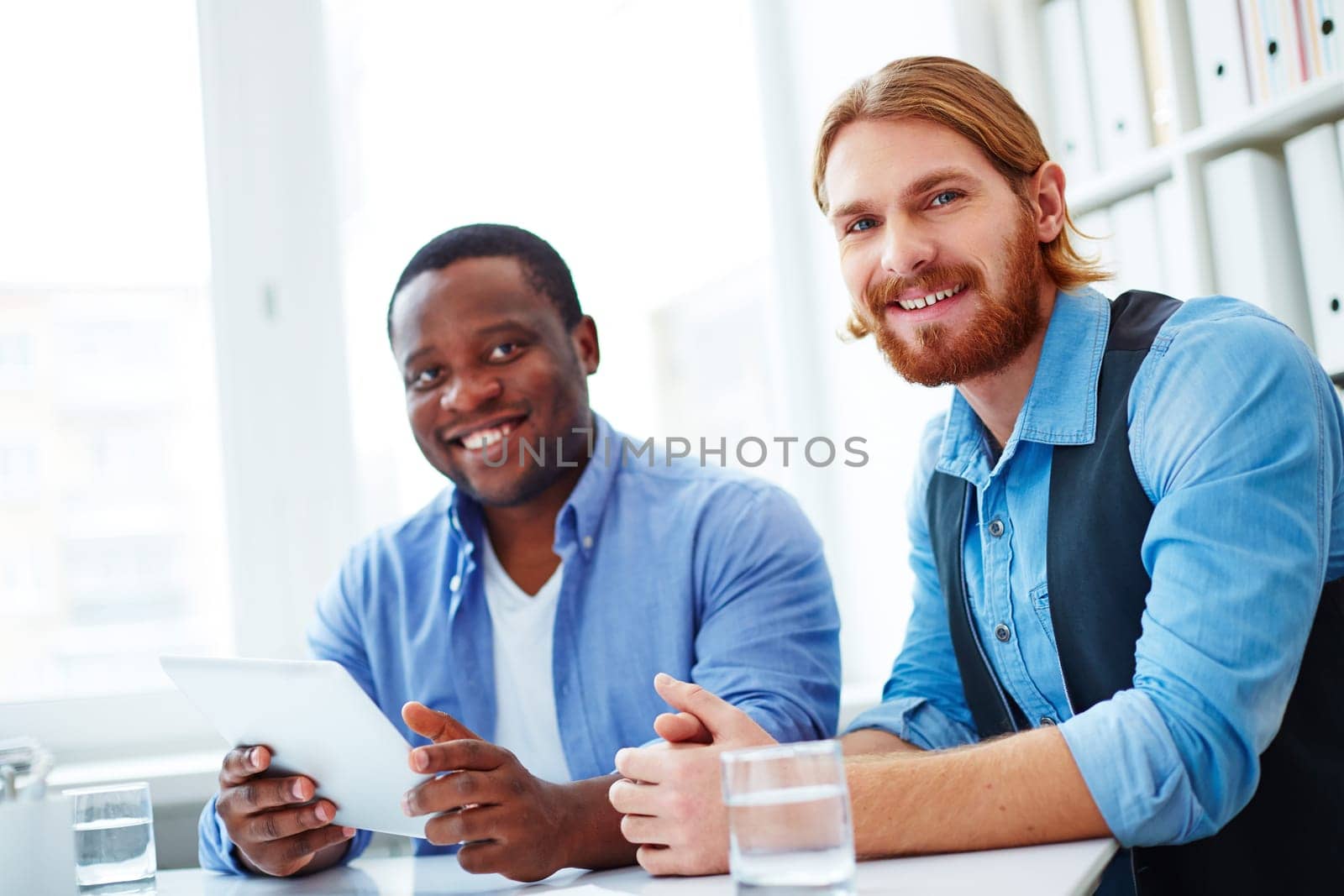 Portrait of two colleagues looking at camera