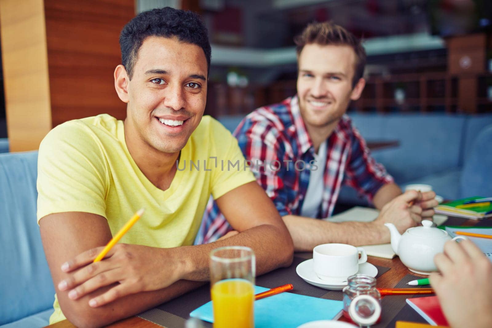 Two boys at breakfast sitting and looking at camera