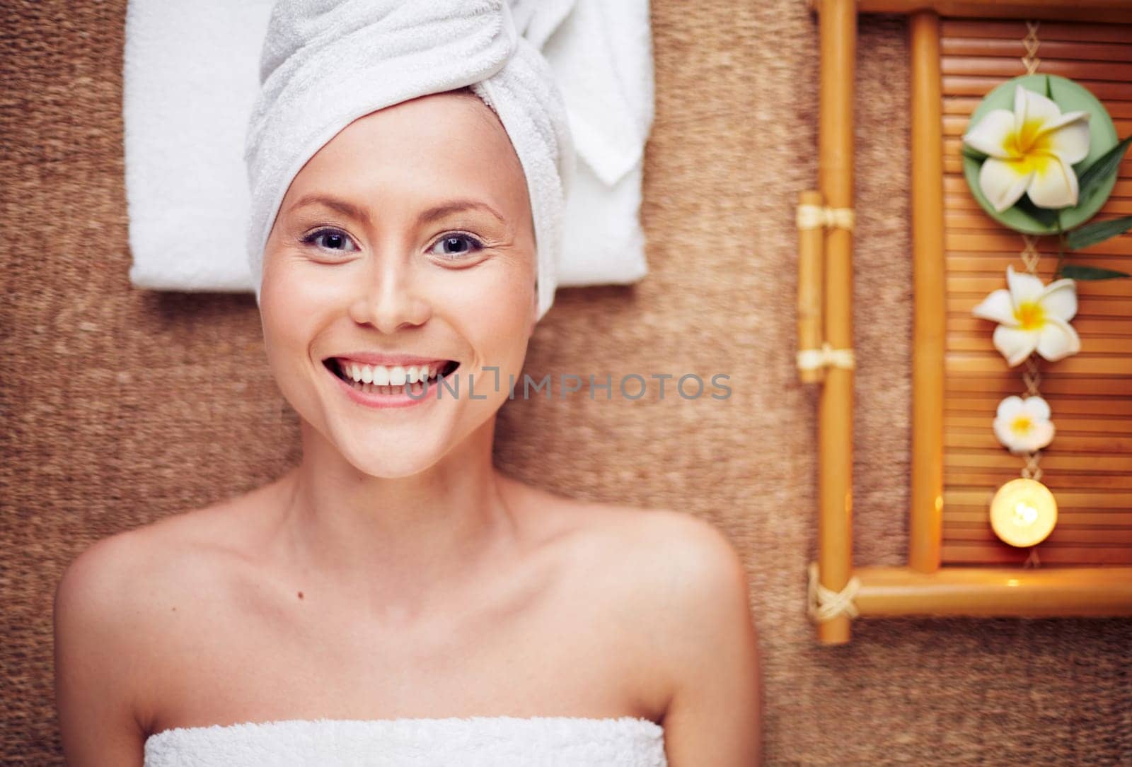 Woman lying on massage table and smiling