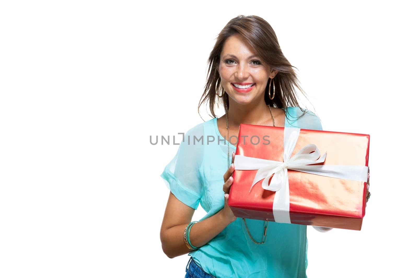 Happy attractive young woman with red gift with white bow Cheerfully isolated against white background with text space