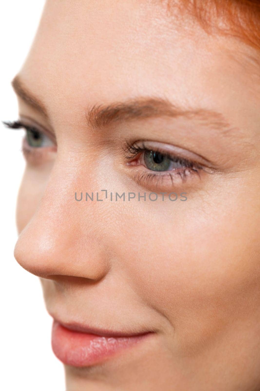 Close-up of a female face with eye lip nose and eyebrows isolated on white background
