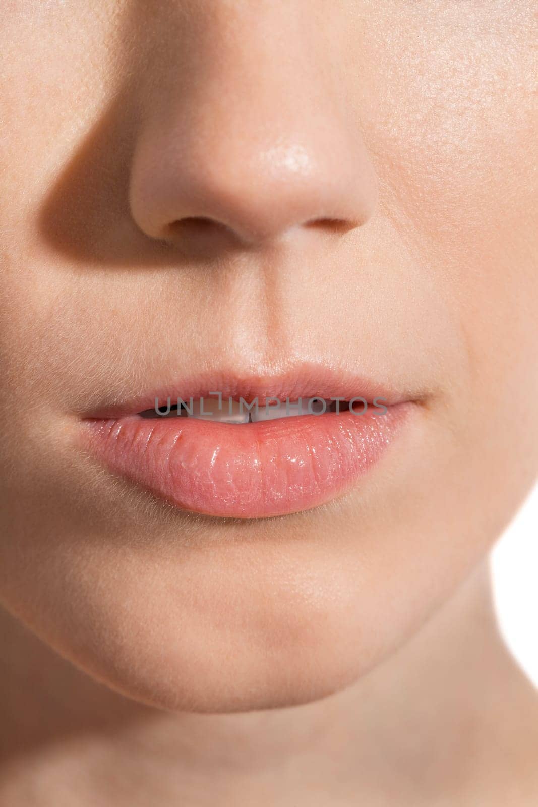 Close-up of a female face with eye lip nose and eyebrows isolated on white background