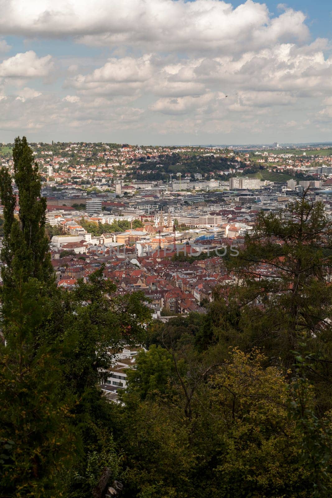 Skyline of Stuttgart with the view over the roofs into the city boiler in Germany with blue sky with small clouds