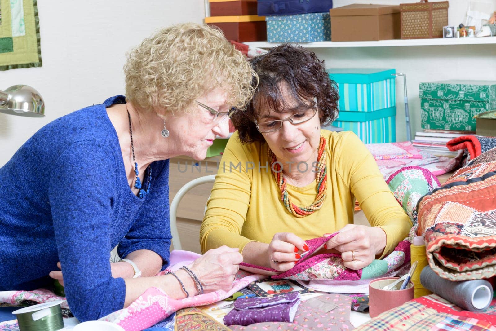 two women working on their patchwork in the workshop