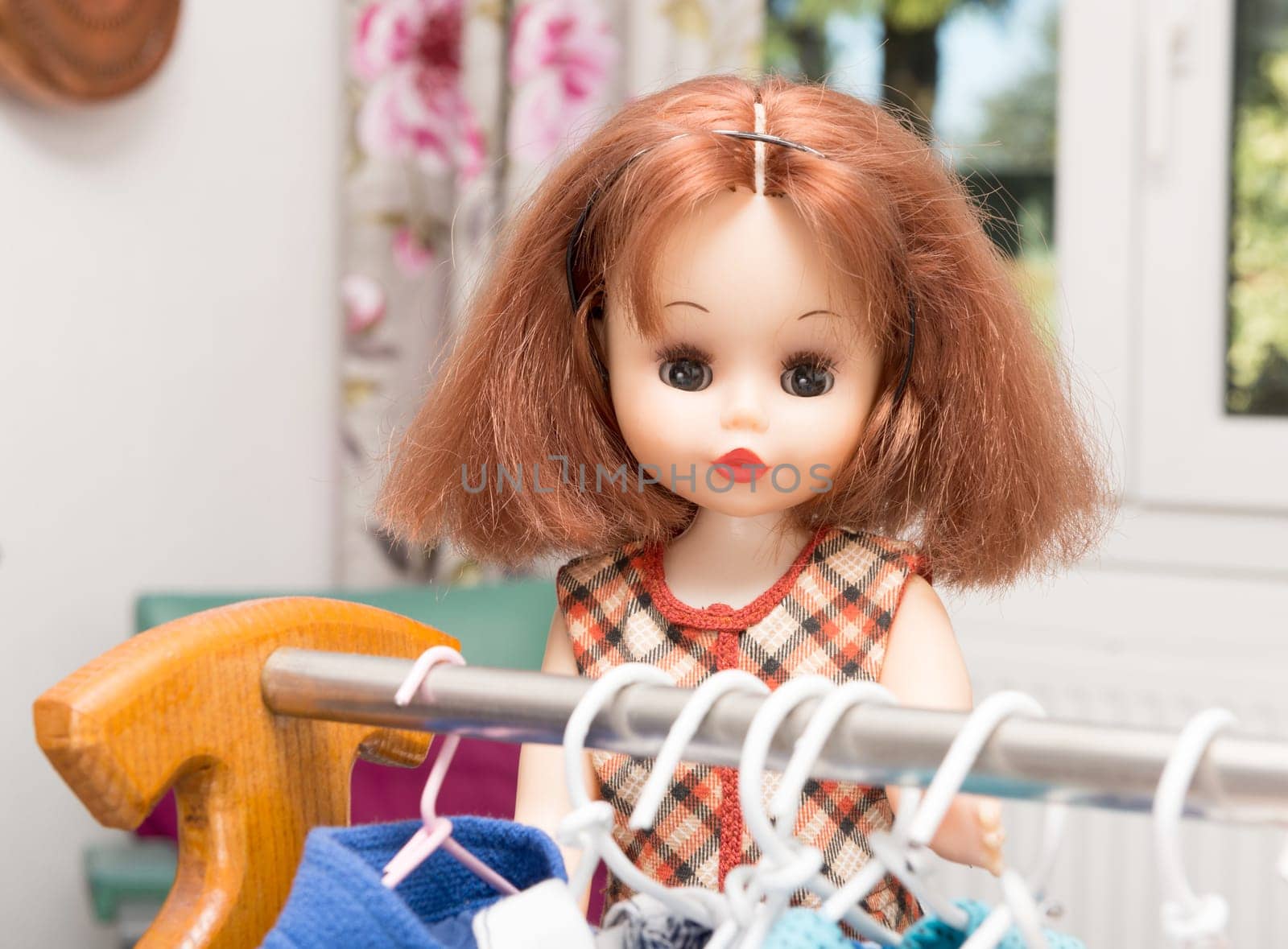 doll with red hair and several dresses
