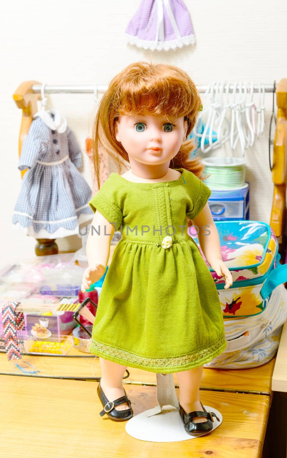 doll with red hair and several dresses